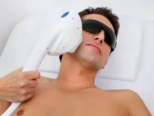 A man with sunglasses on holding an electric device.